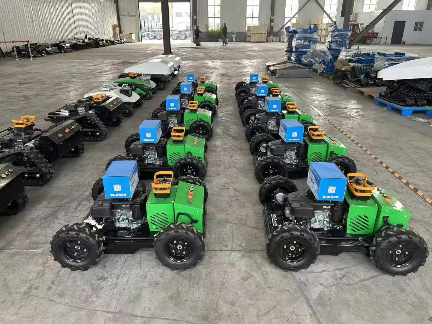Rows of remote mower platforms staged on a factory floor