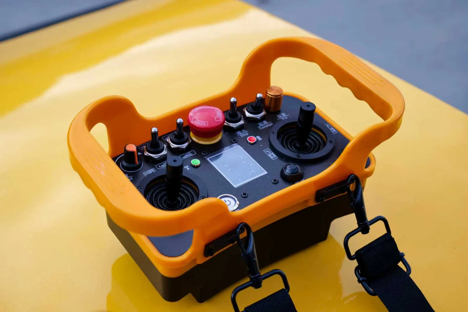Orange industrial remote controller shown in close-up